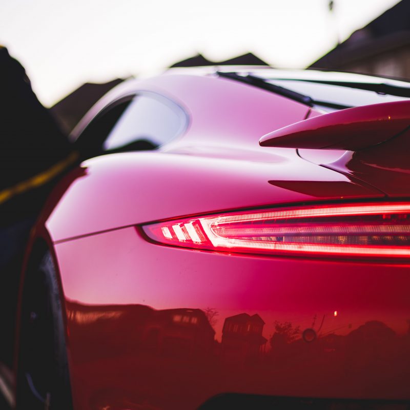 Back view of red Porsche in street